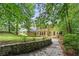 Serene backyard featuring mature trees, lush landscaping, and a stone pathway leading to the home at 1863 Wicks Valley Ne Dr, Marietta, GA 30062