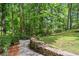 Landscaped stone path leading to backyard seating area with mature trees and peaceful surroundings at 1863 Wicks Valley Ne Dr, Marietta, GA 30062