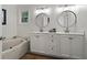 Bright bathroom featuring a soaking tub, double sinks, and modern finishes at 1863 Wicks Valley Ne Dr, Marietta, GA 30062