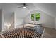 Bright bonus room with vaulted ceilings, large window, and a checkered rug, creating a versatile space at 1863 Wicks Valley Ne Dr, Marietta, GA 30062