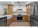 Stylish kitchen featuring wooden cabinetry, stainless steel appliances, and a farmhouse sink at 1863 Wicks Valley Ne Dr, Marietta, GA 30062