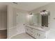 Bathroom featuring a double sink vanity with modern lighting fixtures, and a large mirror at 250 Meadow View Dr, Grayson, GA 30017