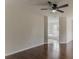 Spacious bedroom featuring a ceiling fan, hardwood floors, and a glimpse into the connected bathroom at 250 Meadow View Dr, Grayson, GA 30017
