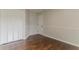 Cozy bedroom featuring hardwood floors, a closet, and neutral wall paint at 250 Meadow View Dr, Grayson, GA 30017