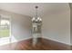 Inviting dining room with hardwood floors, natural light, and modern light fixture at 250 Meadow View Dr, Grayson, GA 30017