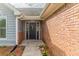 Inviting front entrance with a black door, brick accents, and well-maintained landscaping at 250 Meadow View Dr, Grayson, GA 30017