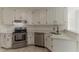 Stylish kitchen with stainless steel appliances, white cabinets, and quartz countertops at 250 Meadow View Dr, Grayson, GA 30017