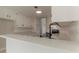 Bright kitchen with white cabinets, quartz countertops, stainless steel appliances and a tile floor at 250 Meadow View Dr, Grayson, GA 30017