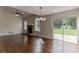 Open living room with hardwood floors, brick fireplace, and sliding glass door to the backyard at 250 Meadow View Dr, Grayson, GA 30017