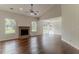 Bright living room featuring a brick fireplace, large windows, and hardwood flooring at 250 Meadow View Dr, Grayson, GA 30017