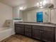 Bathroom featuring double sink vanity with granite countertops, and a well-lit mirror at 3291 Wild Basil Ln, Buford, GA 30519