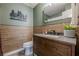 Bathroom featuring wood accent walls, a wood vanity and a tiled floor at 3291 Wild Basil Ln, Buford, GA 30519