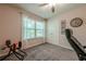 Bedroom featuring a ceiling fan, neutral paint, carpeted floors, and a double door closet at 3291 Wild Basil Ln, Buford, GA 30519