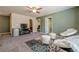 Spacious bonus room featuring a ceiling fan, modern furniture, and a decorative accent wall at 3291 Wild Basil Ln, Buford, GA 30519