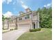 Charming townhome with brick accents, two-car garage, and well-manicured lawn at 3291 Wild Basil Ln, Buford, GA 30519