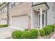 Charming townhome featuring brick accents, an attached garage, manicured landscaping, and a welcoming entrance at 3291 Wild Basil Ln, Buford, GA 30519