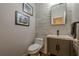 Stylish half bathroom features a modern vanity and stone accent wall at 3291 Wild Basil Ln, Buford, GA 30519