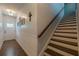 Hallway leading to the staircase with shiplap accent and views of the front door at 3291 Wild Basil Ln, Buford, GA 30519