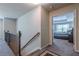 Hallway leading to a bedroom, featuring a view of a well-furnished bedroom and natural lighting at 3291 Wild Basil Ln, Buford, GA 30519