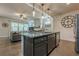 Open kitchen layout flowing into the living room, stainless appliances, and a central island at 3291 Wild Basil Ln, Buford, GA 30519