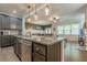 Open kitchen with large island flowing into the living room at 3291 Wild Basil Ln, Buford, GA 30519