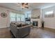Inviting living room featuring a stacked stone fireplace and hardwood floors at 3291 Wild Basil Ln, Buford, GA 30519