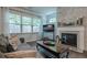 Comfortable living room showcasing a stacked stone fireplace and wood floors at 3291 Wild Basil Ln, Buford, GA 30519