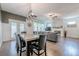 Open concept living space with fireplace flowing into the dining room with outdoor access at 3291 Wild Basil Ln, Buford, GA 30519