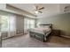 Main bedroom features tray ceilings, carpet, fan, and natural light from large windows at 3291 Wild Basil Ln, Buford, GA 30519