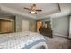 Comfortable main bedroom with a trey ceiling, a ceiling fan, and an ensuite bathroom at 3291 Wild Basil Ln, Buford, GA 30519