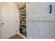 Convenient mudroom space with built-in shelving and a sliding barn door at 3291 Wild Basil Ln, Buford, GA 30519