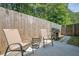 Cozy patio featuring a grill, table and chairs, and a privacy fence, perfect for outdoor dining and relaxation at 3291 Wild Basil Ln, Buford, GA 30519