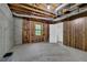 Unfinished basement with exposed ceiling, concrete walls, and a window at 6896 Heardsville Rd, Cumming, GA 30028