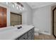 Bathroom with a white countertop, gray cabinets, shower, toilet, and decorative vanity light at 6896 Heardsville Rd, Cumming, GA 30028