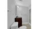Bathroom with a vanity with a brown cabinet, shower, and toilet at 6896 Heardsville Rd, Cumming, GA 30028