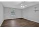 Bedroom with hardwood floors, neutral walls, ceiling fan, and window with a treed view at 6896 Heardsville Rd, Cumming, GA 30028