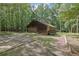Wood cabin-style home with a two-car garage and forest surroundings at 6896 Heardsville Rd, Cumming, GA 30028