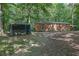 Exterior view of a home and chicken coop surrounded by trees at 6896 Heardsville Rd, Cumming, GA 30028