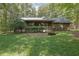 Charming cabin-style home with a covered porch surrounded by a green lawn at 6896 Heardsville Rd, Cumming, GA 30028