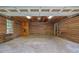 Spacious two-car garage with wood paneled walls at 6896 Heardsville Rd, Cumming, GA 30028