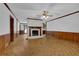 Bright living room featuring a brick fireplace and classic hardwood floors at 6896 Heardsville Rd, Cumming, GA 30028