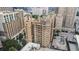 An aerial view of building featuring balconies and ample parking at 75 Ponce De Leon Ne Ave # 1004, Atlanta, GA 30308