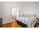 Bright bedroom featuring hardwood floors, a large bed, and an ensuite bathroom at 75 Ponce De Leon Ne Ave # 1004, Atlanta, GA 30308