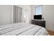 Relaxing bedroom with a comfortable bed, dresser, and natural light from the window at 75 Ponce De Leon Ne Ave # 1004, Atlanta, GA 30308