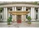 Ornate building entrance with a gold canopy, red carpet, and potted trees at 75 Ponce De Leon Ne Ave # 1004, Atlanta, GA 30308
