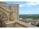 Rooftop view showcasing the city skyline and lush greenery, framed by a decorative architectural element at 75 Ponce De Leon Ne Ave # 1004, Atlanta, GA 30308