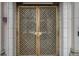 Close-up of the building's front doors with a decorative metal design at 75 Ponce De Leon Ne Ave # 1004, Atlanta, GA 30308