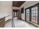 Hallway leading to an outdoor deck area, featuring decorative tiling and iron railings at 75 Ponce De Leon Ne Ave # 1004, Atlanta, GA 30308