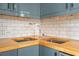 Clean corner sink with stylish faucet, butcher block countertop and subway tile backsplash at 75 Ponce De Leon Ne Ave # 1004, Atlanta, GA 30308