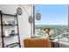 Bright living area featuring unique decor, shelving, and a large window with scenic city views at 75 Ponce De Leon Ne Ave # 1004, Atlanta, GA 30308